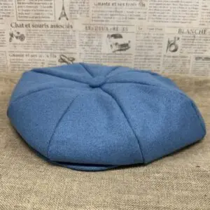 Blue wool eight-panel newsboy cap.