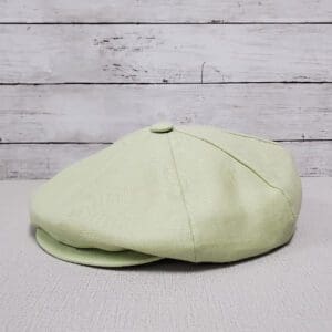 A light green hat is sitting on top of a table.