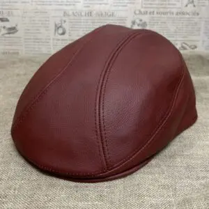 A brown leather cap is sitting on the floor.