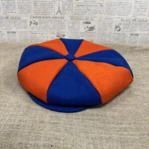 Blue and orange eight-panel newsboy cap.