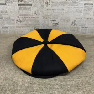 Black and gold eight-panel newsboy cap.