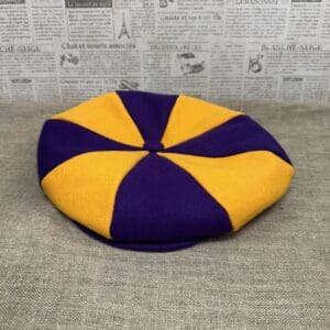 Purple and gold eight-panel newsboy cap.